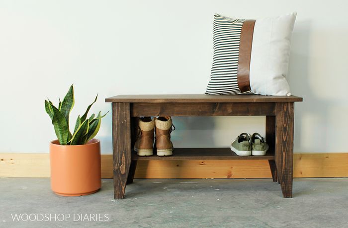A small wooden entryway bench