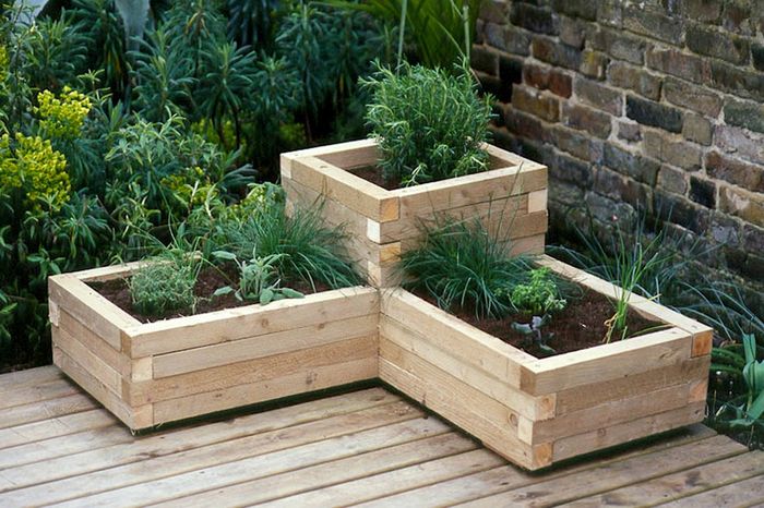 A simple wooden planter box on a workbench
