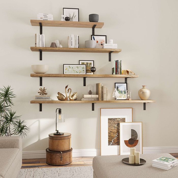 A wooden wall-mounted floating shelf